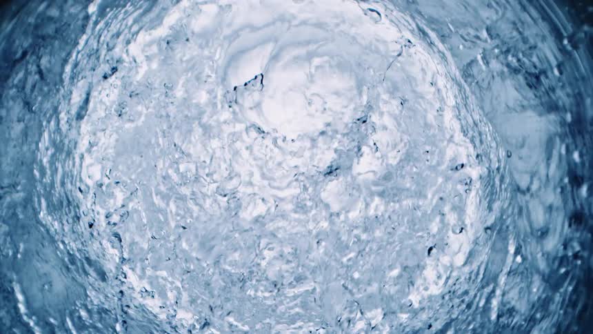 Rings of white circles are sitting on the surface as they sink underwater bubbles rise in the ripples as the water moves