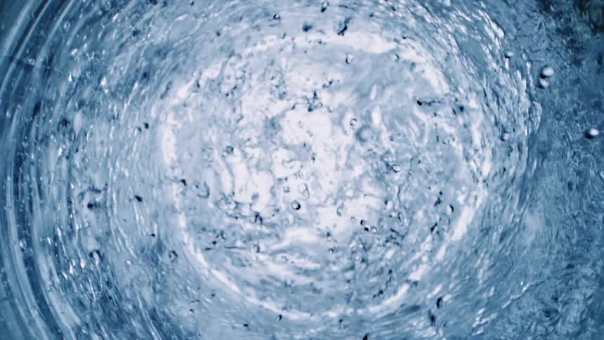 Water ripples and whirls in a glass tube