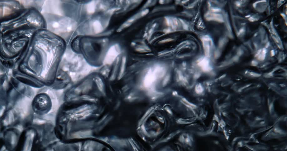 A close up of clear liquids moving and jostling around