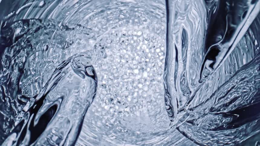A close up of water pouring down into more water