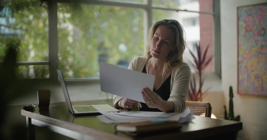 A woman looks through papers in the office