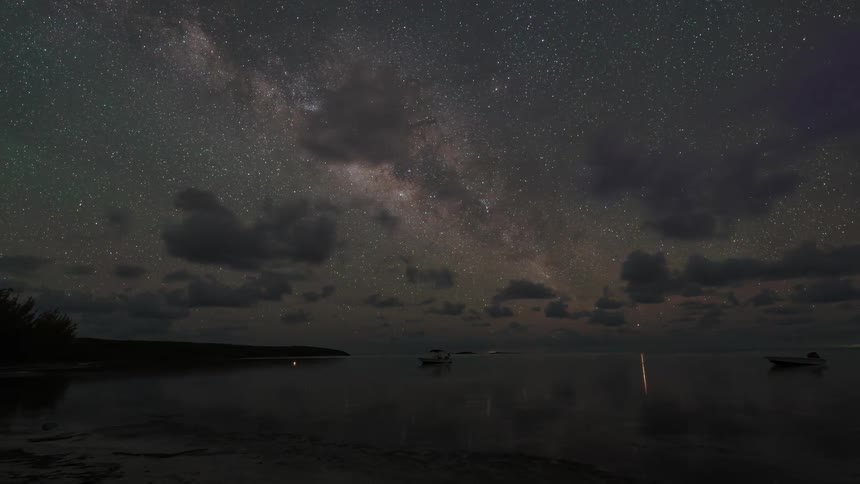 Time lapse of starry sky over the calm sea