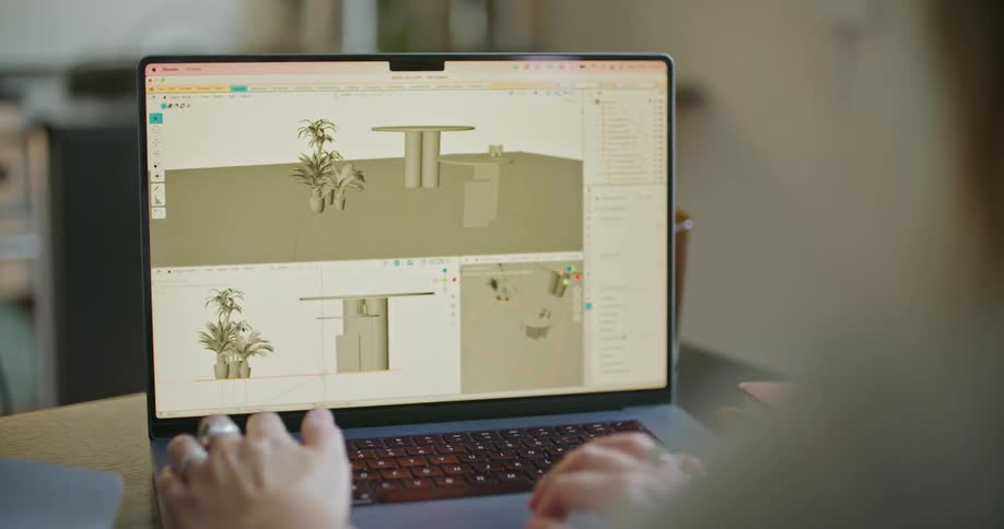 A person uses their laptop in order to create a virtual design