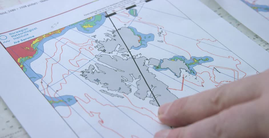 A person is pointing to places on a map