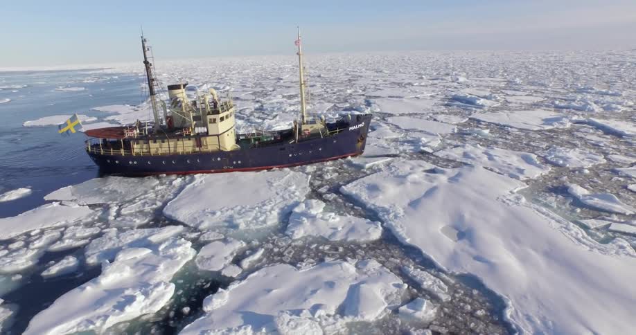 A boat travels through icy water