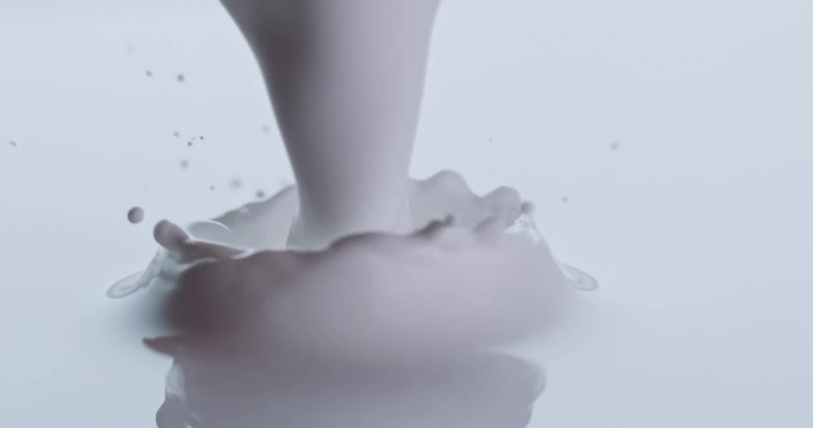 Close up of white paint pouring into white liquid