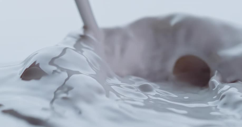Milk is poured in slow motion forming a pool