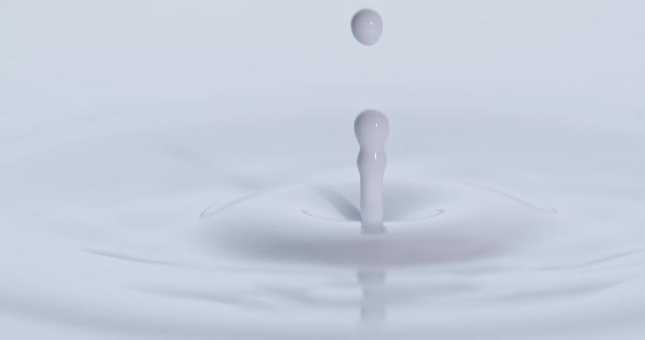 A drop of white liquid falls
