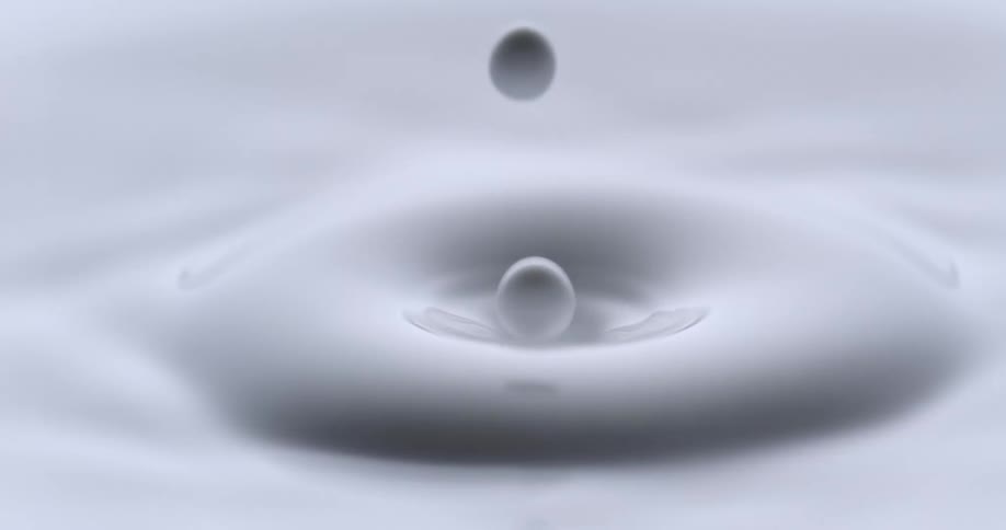 Water droplet falls into white paint liquid