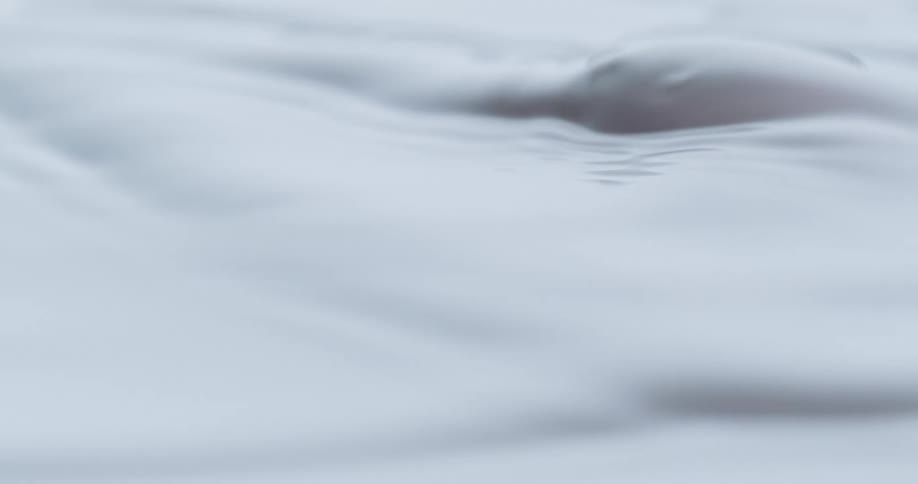 A white foamy liquid moves back and forth