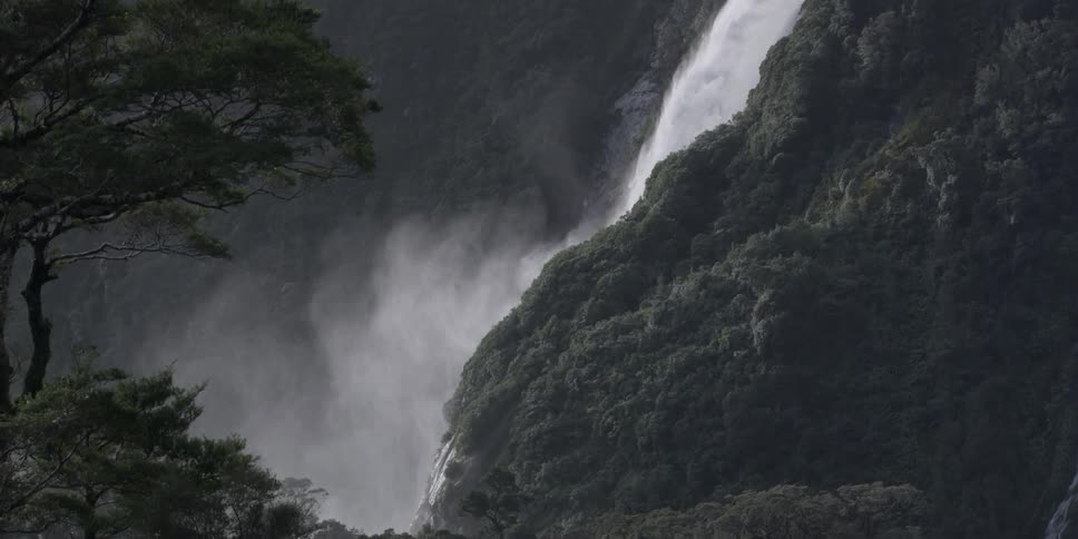 A waterfall is pouring off the side of a mountain
