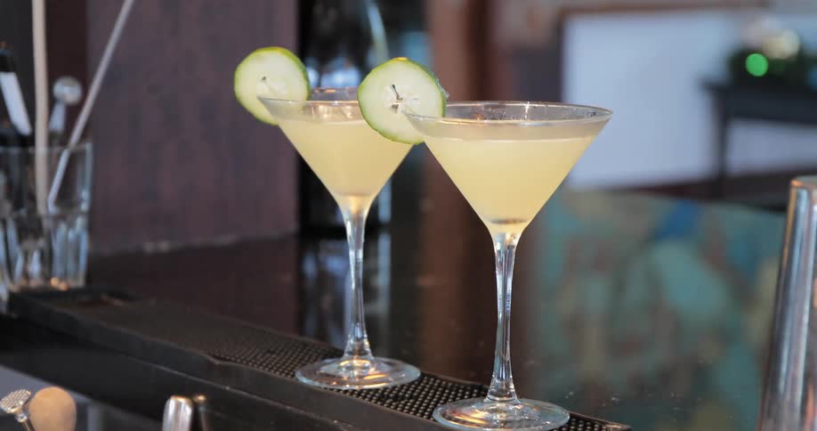 A person is preparing two drinks