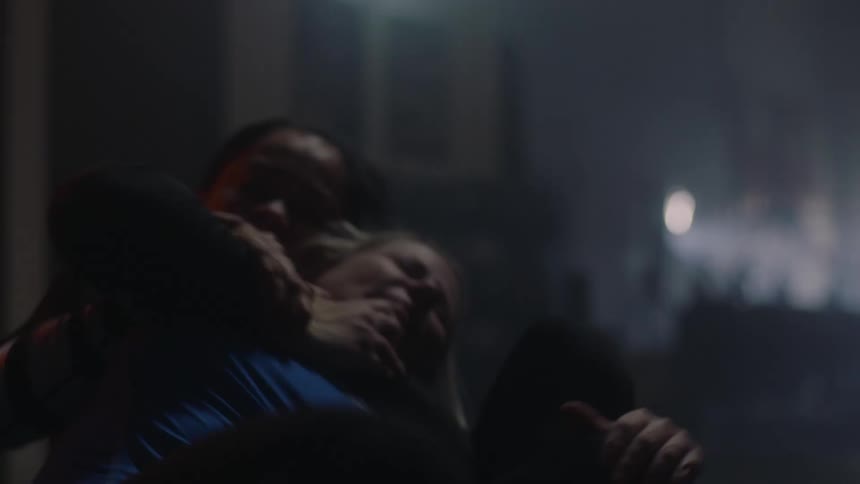 Two woman compete against each other while grappling in a gym