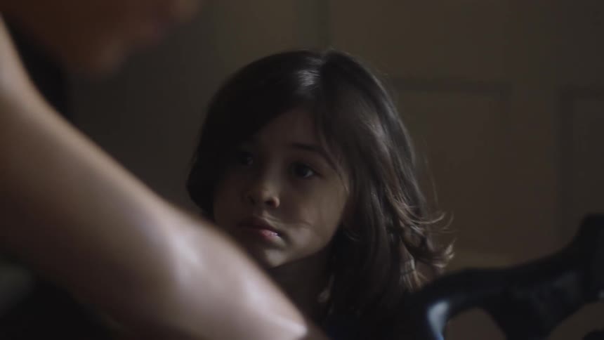 A child watches a woman work out