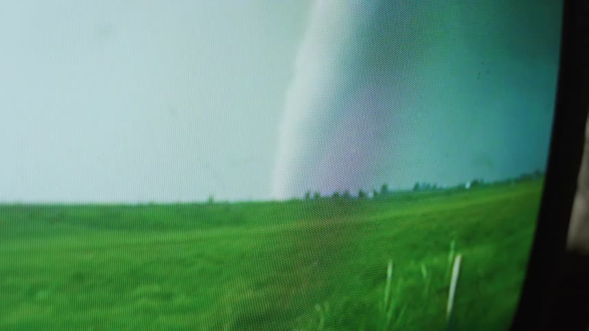 Close up of television screen showing hurricane in the field