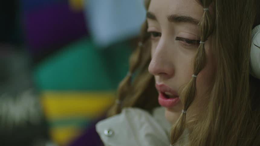 A womans face close up while she looks very upset crying and distraught
