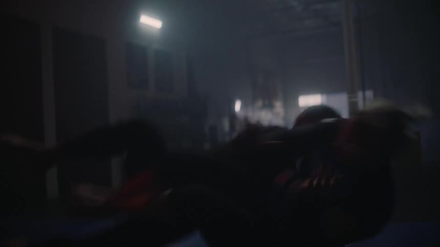 A woman holds on to a girl around the waist as they both fall to the ground