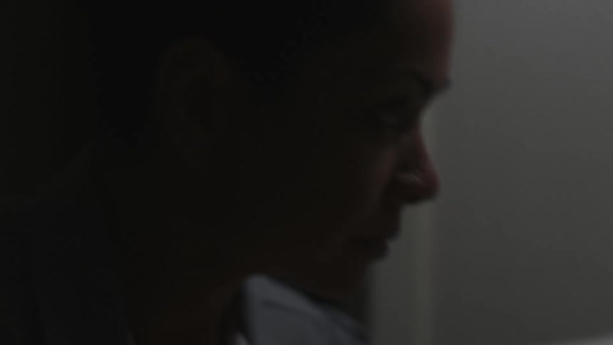 A womans face close up as she moves around and looks aggressively