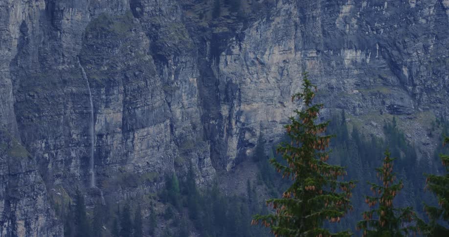 A waterfall comes out of a tall cliff