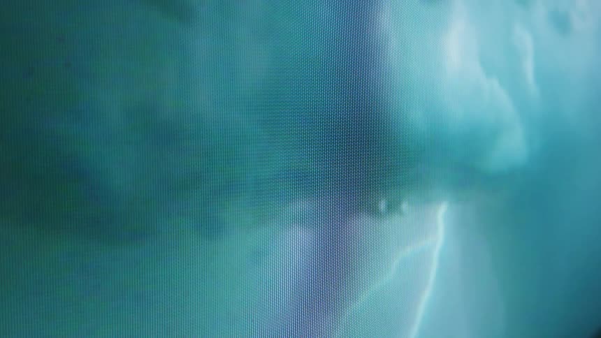 Lightning flashes on the television