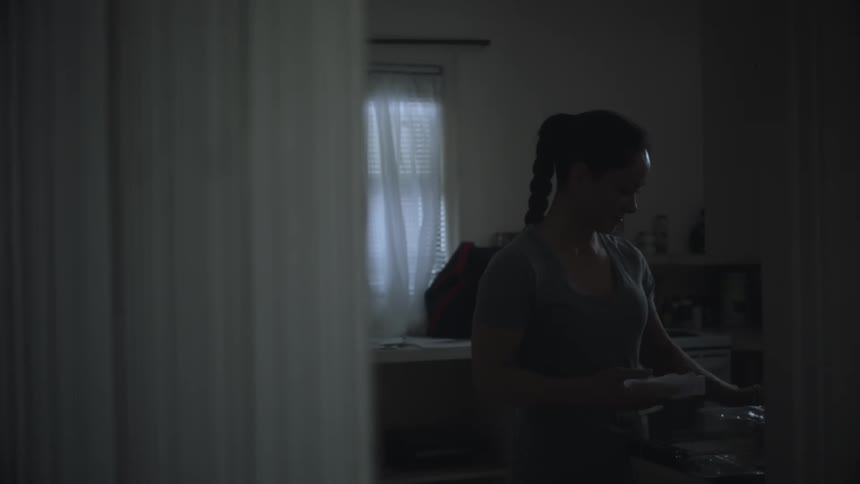A woman is cooking in the kitchen