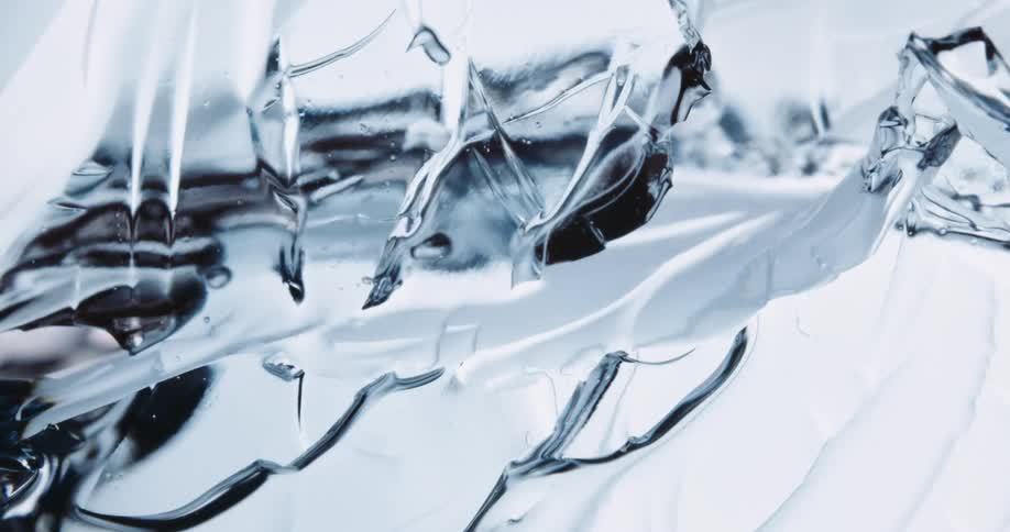 A clear piece of crystalline ice cracks and breaks into pieces