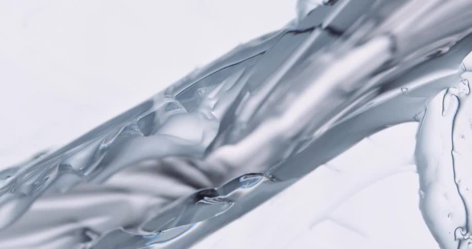 A piece of crystal clear ice cracks into two separate pieces