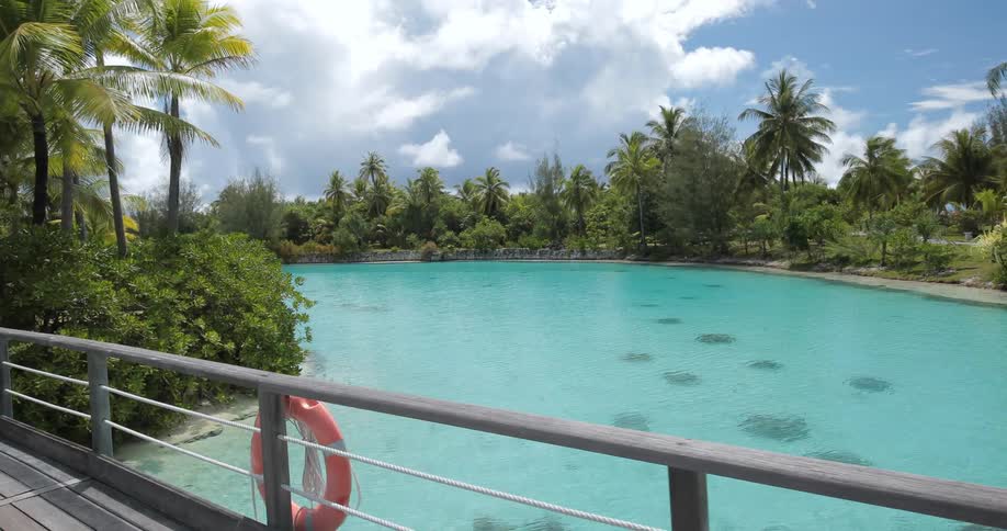 Going across a walkway perched over a crystal blue lagoon