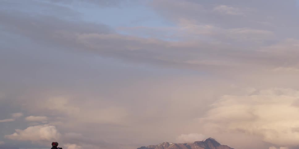 People taking pictures in a mountainous area on a very cloudy day