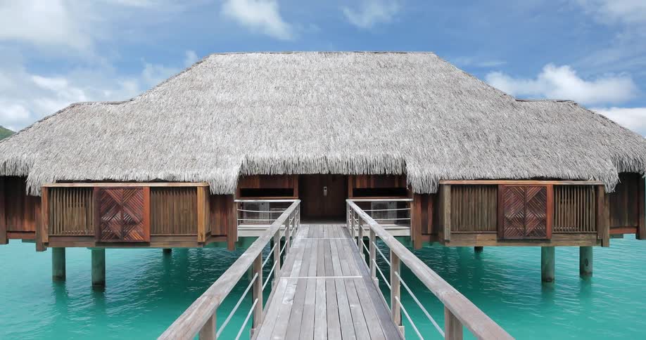 A boardwalk leads to a house built on the water