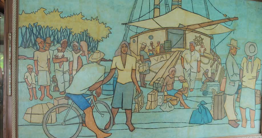 A multicolored painting hangs near a window
