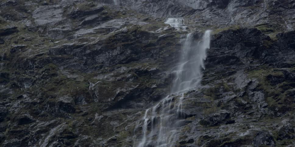 Water is pouring down the side of a cliff
