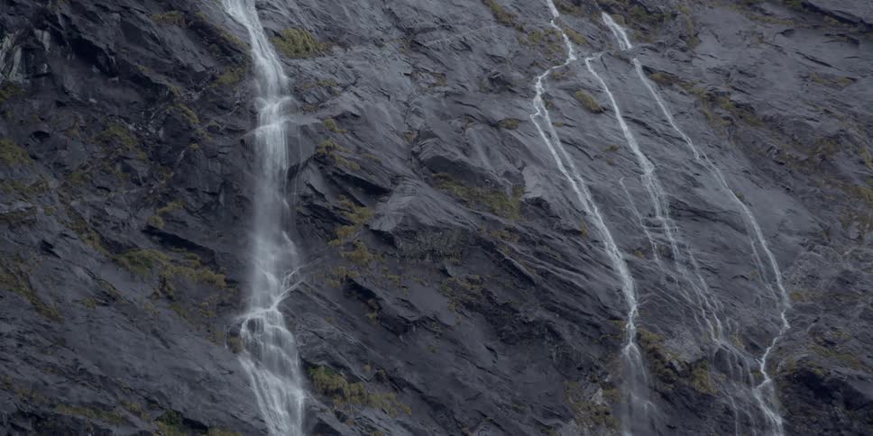 Water pours down the side of a cliff