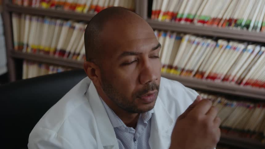 A young man is working inside of a clinic in the day time