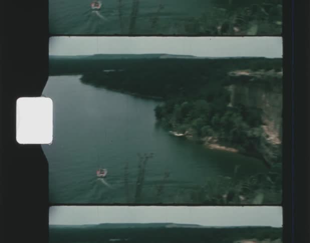 A small boat sails by the island
