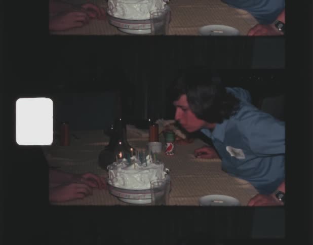 Film footage of a man blowing out candles on his birthday