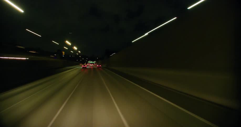 A timelapse from the point of view of a vehicle driving through a city road at night