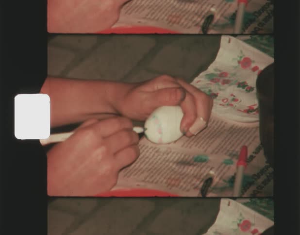 Person trying to decorate white eggshaped object has to test dry pen