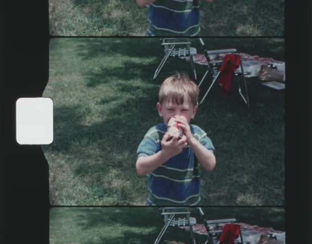 A young boy drinks a can of soda during a picnic