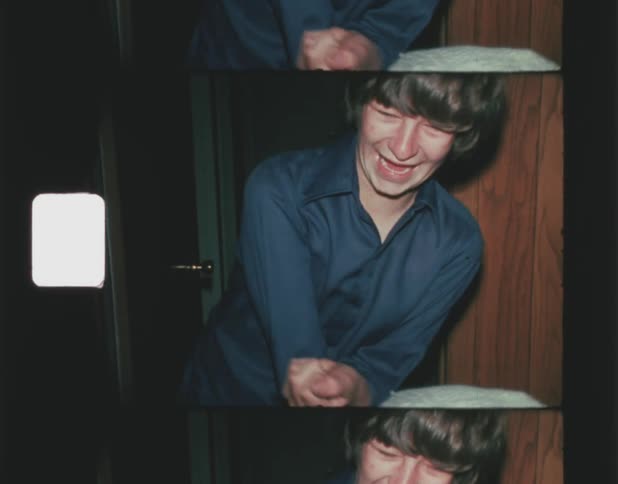 Two youths play and smile near doorway