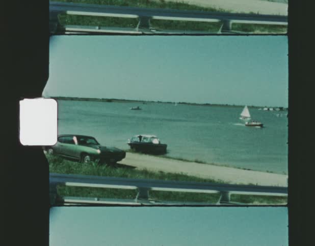 Landscape of boats sailing on water and people going in sea on the beach