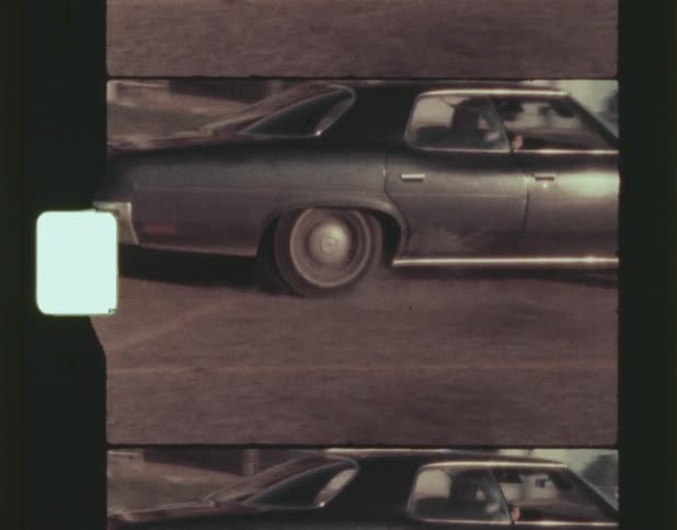 Film footage of a person driving a vehicle at midday
