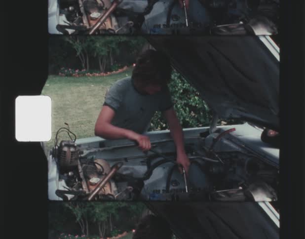 A man works under the hood of his car