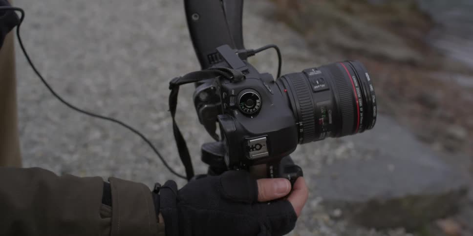 A person is adjusting a camera