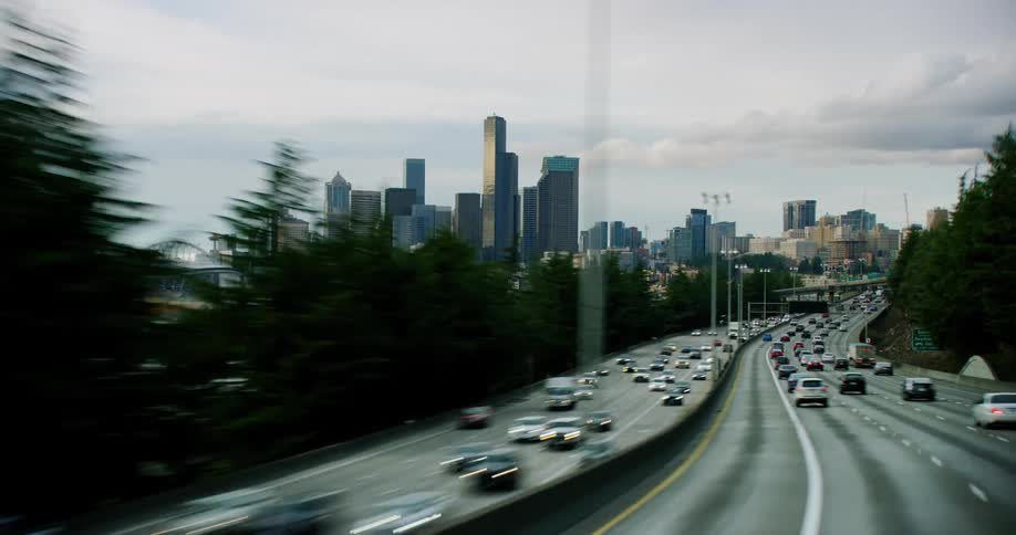 Hyper lapse shot of full traffic flowing into and out of downtown Seattle as commuters navigate the twisting and turning interstate highway system