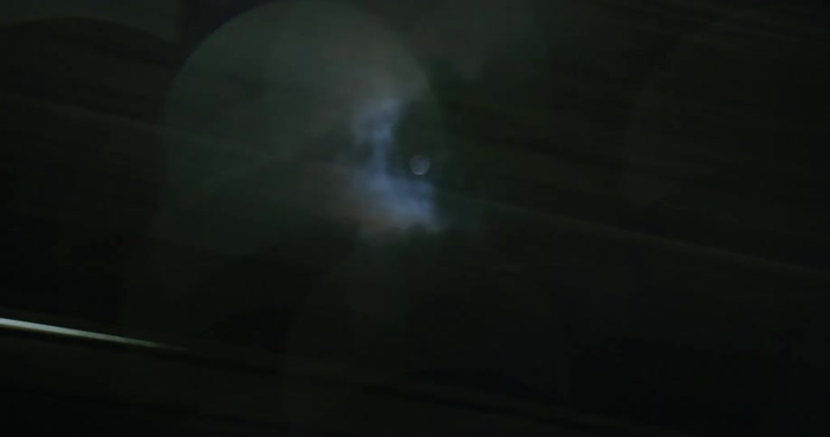 A dazzling display of fastmoving lights illuminating the sky accompanied by the serene presence of the moon creating a mesmerizing spectacle that captivates the viewer