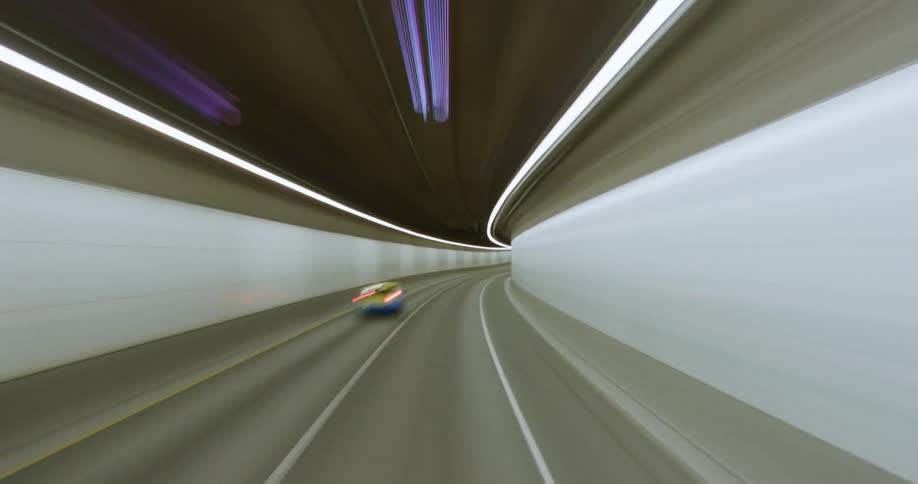 A vehicle speeds across a tunnel as cars drive past it and comes out into the night