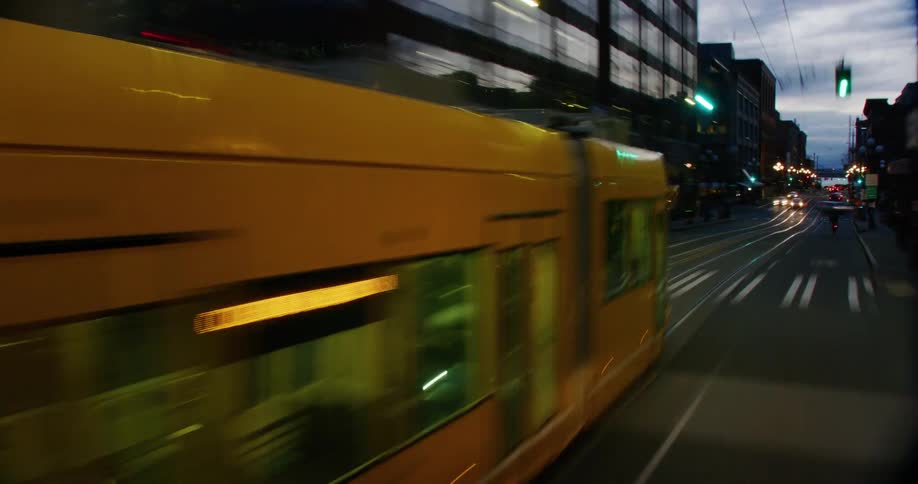 The view is of the downtown area and vehicles are driving down the highway