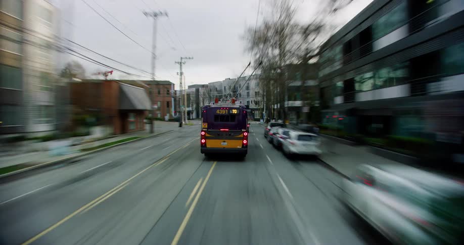 A time lapse of a city with bustling traffic and a public transport bus traveling the road