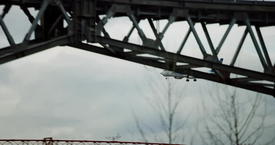 An airplane is starting its landing in cloudy weather